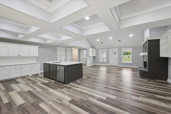 a kitchen with sink cabinets and wooden floor