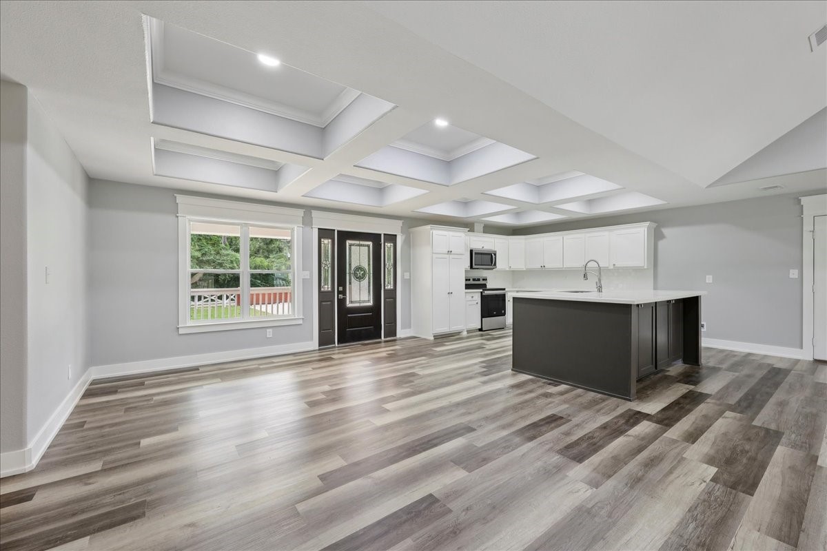 8679 Massey Lake Road Silsbee, TX 77656 - Photo 9 of 37 a view of an empty room with wooden floor and a window