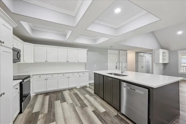 a bedroom with a large bed and a chandelier