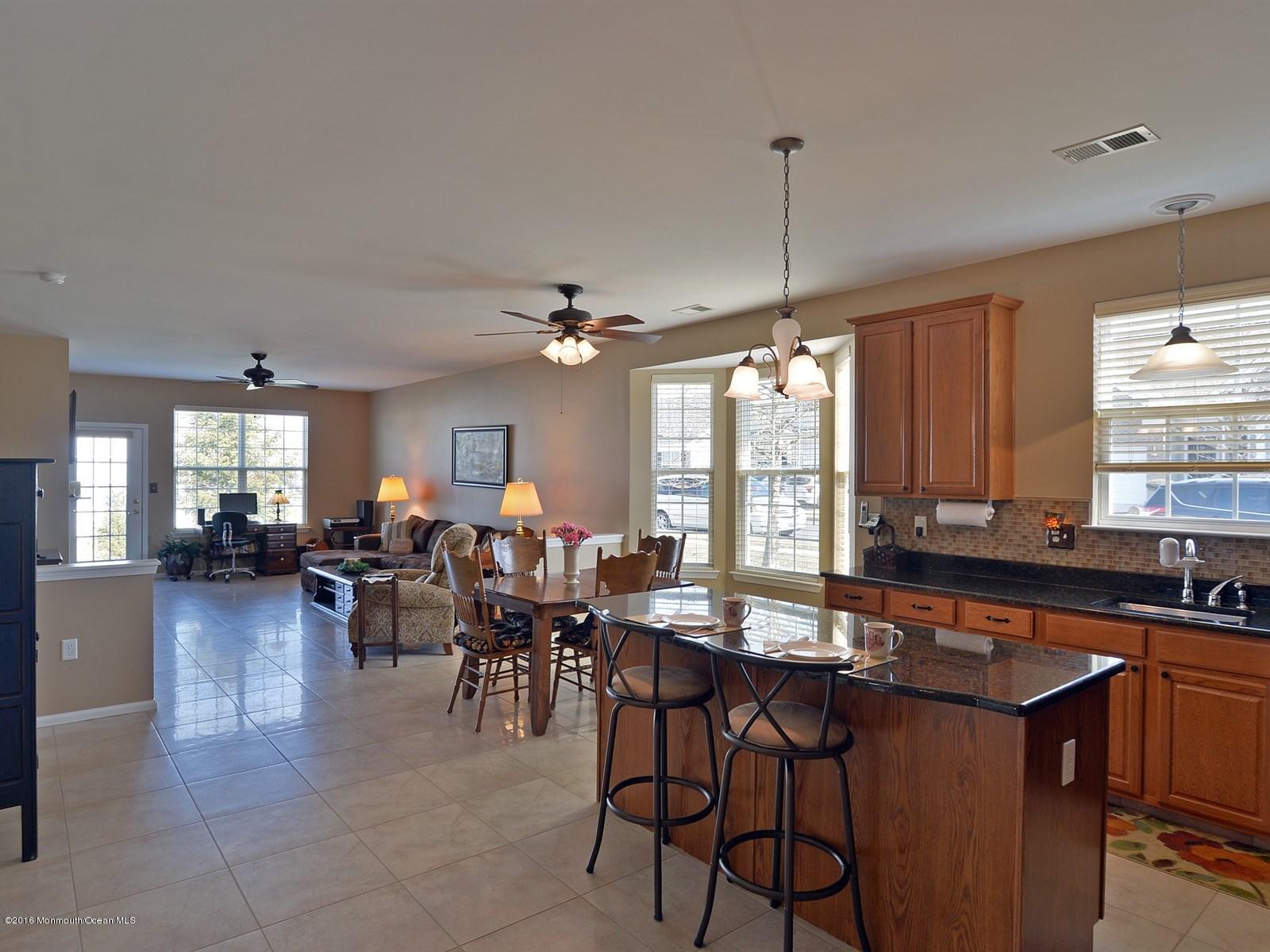 33 Criollo Road Manalapan, NJ 07726 - Photo 5 of 22 a group of people sitting in a living room