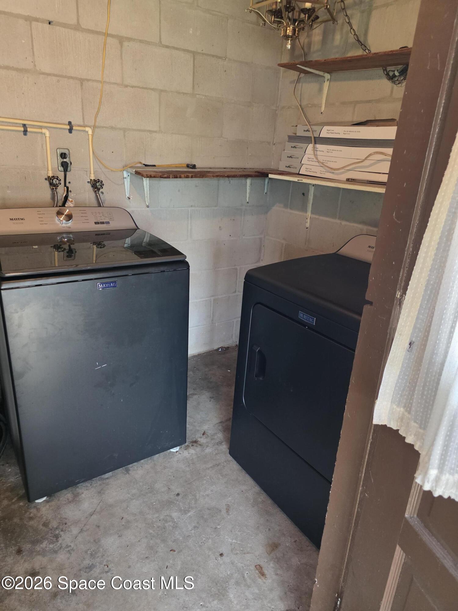 2910 Zephyr Lane Melbourne, FL 32935 - Photo 11 of 16 a kitchen with a sink and a refrigerator