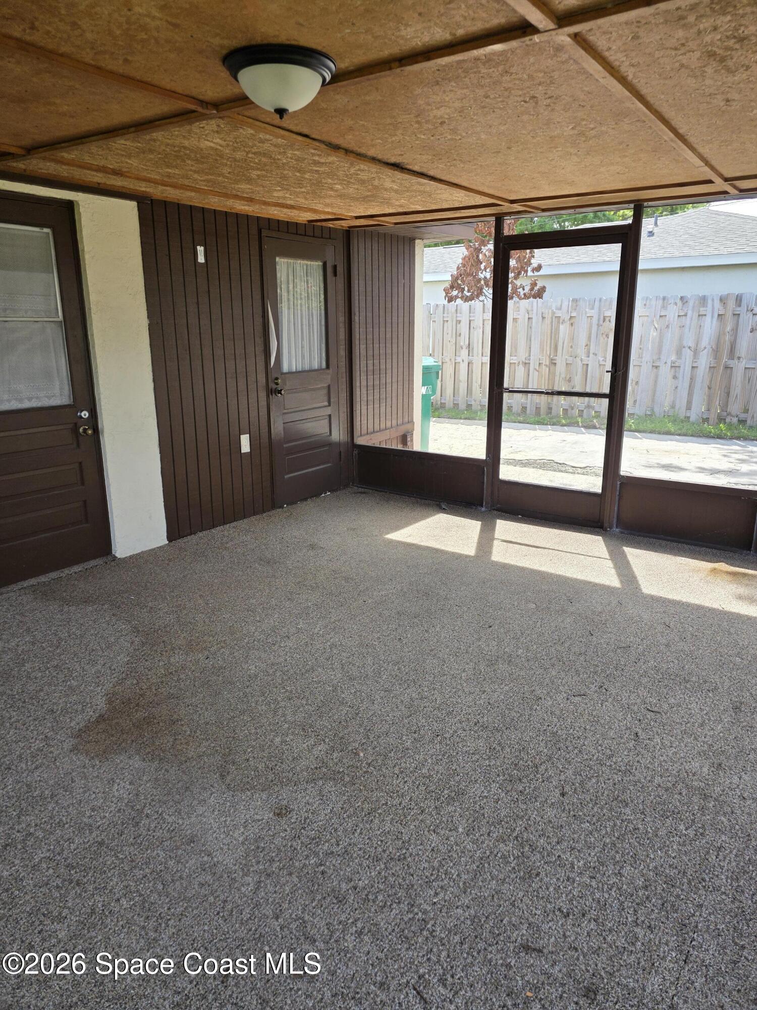 2910 Zephyr Lane Melbourne, FL 32935 - Photo 12 of 16 a view of an empty room with a sliding door