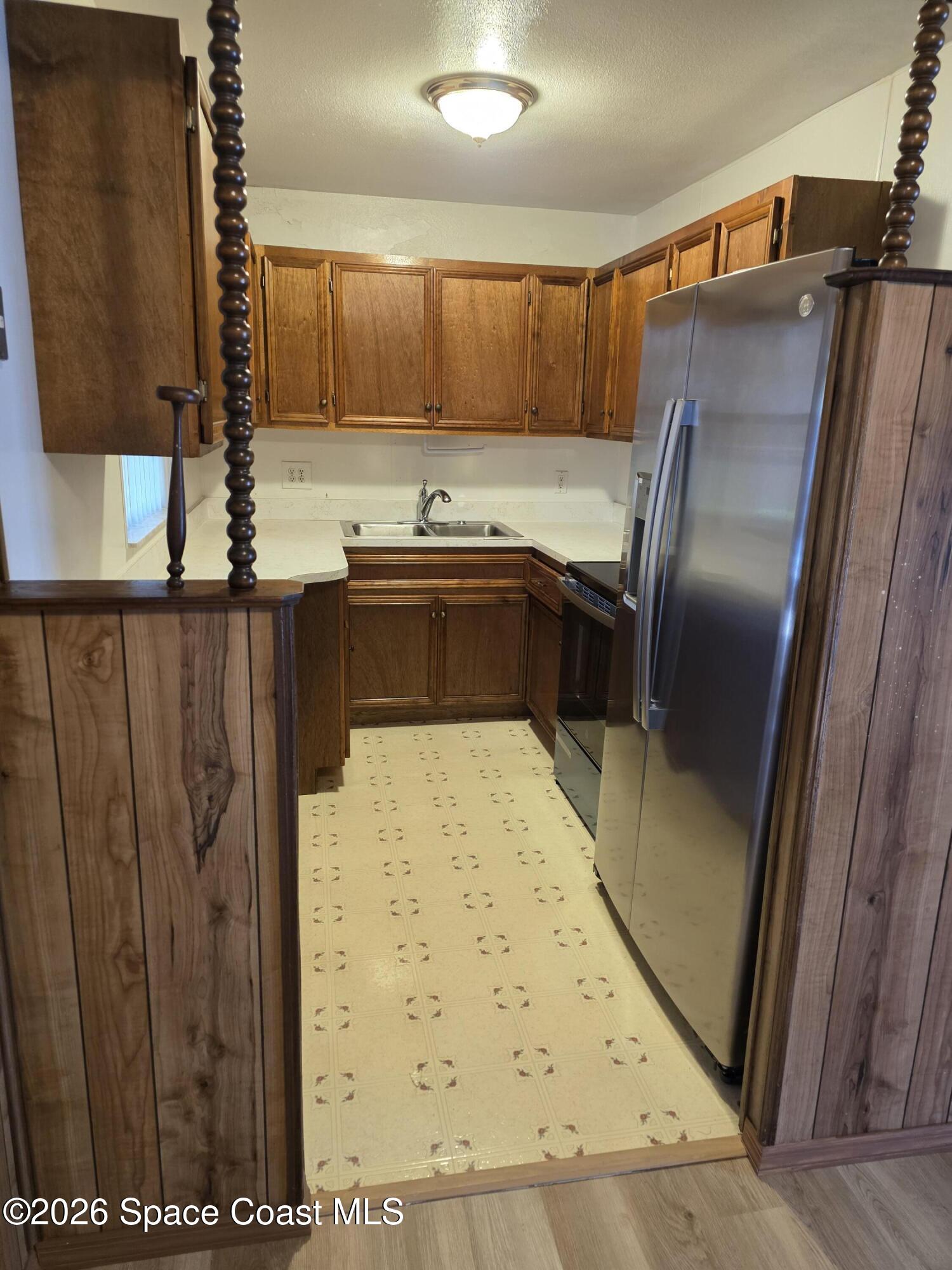 2910 Zephyr Lane Melbourne, FL 32935 - Photo 5 of 16 a kitchen with stainless steel appliances a refrigerator and a stove