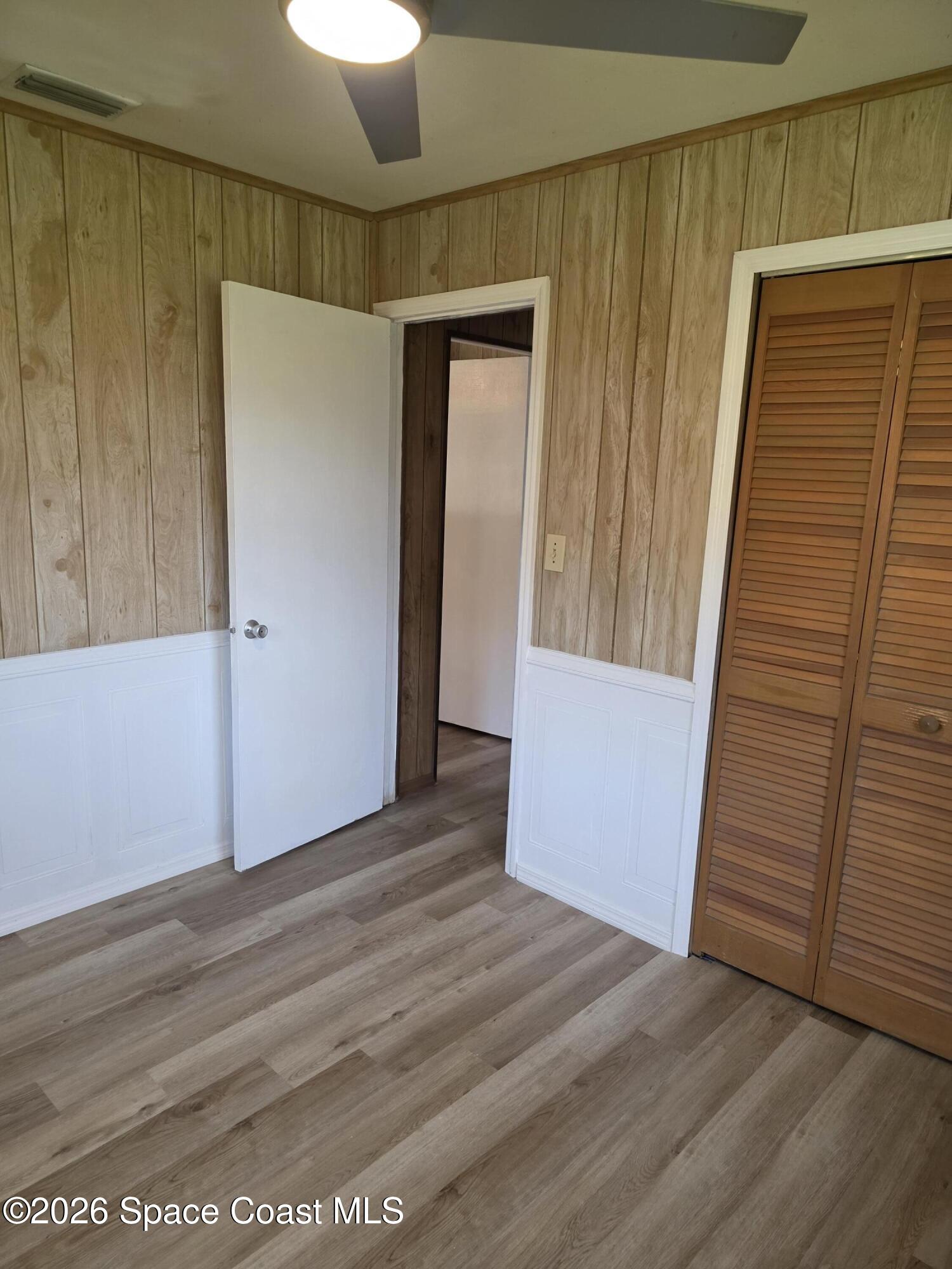 2910 Zephyr Lane Melbourne, FL 32935 - Photo 7 of 16 a view of an empty room with wooden floor and entryway