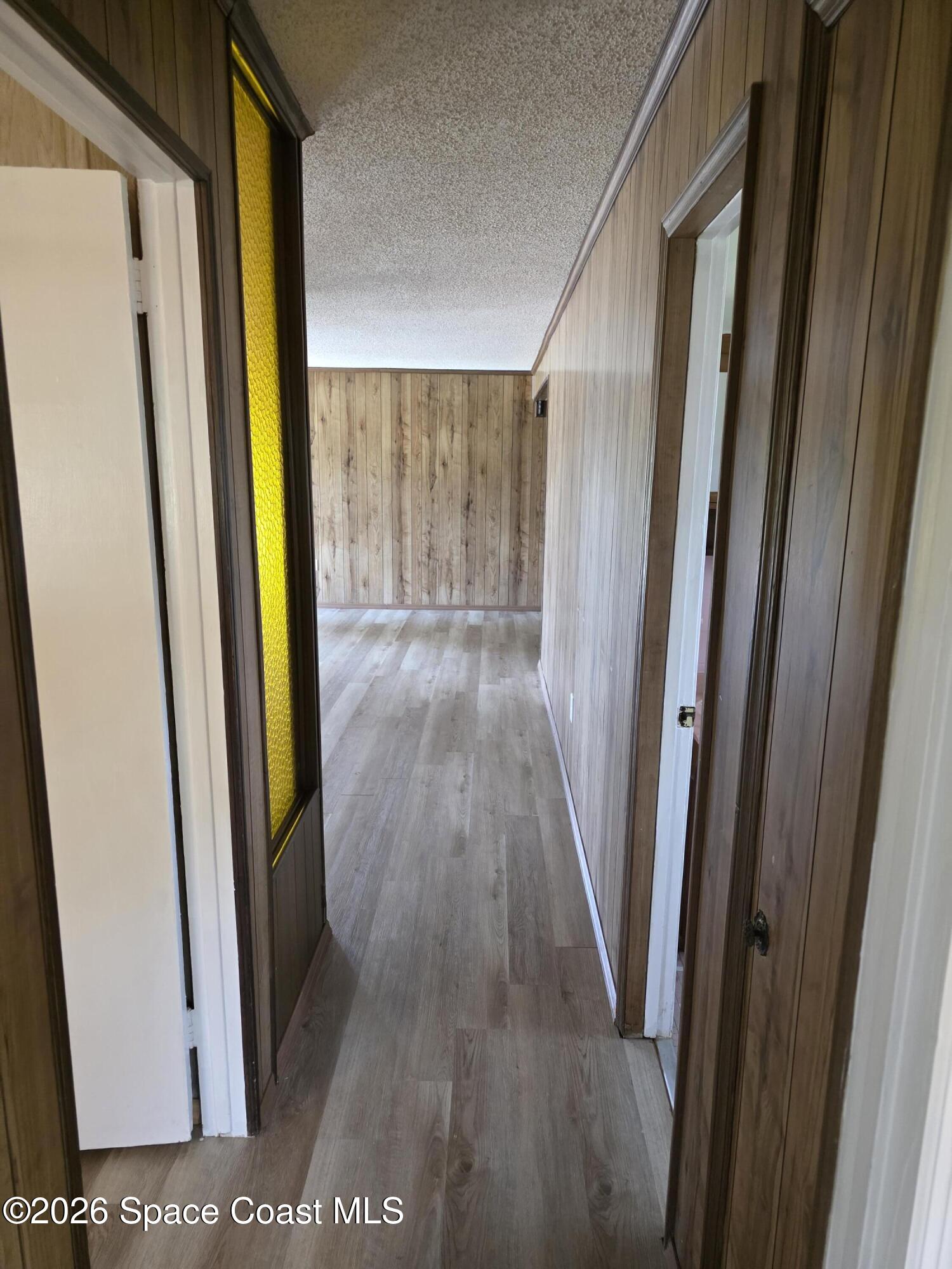 2910 Zephyr Lane Melbourne, FL 32935 - Photo 8 of 16 a view of a hallway with wooden floor