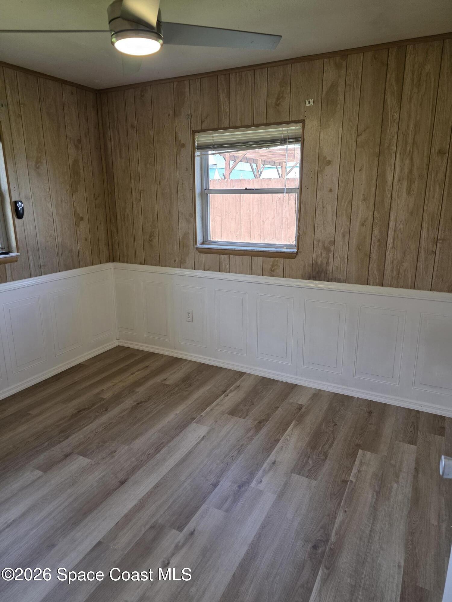2910 Zephyr Lane Melbourne, FL 32935 - Photo 9 of 16 a view of an empty room with wooden floor and a window