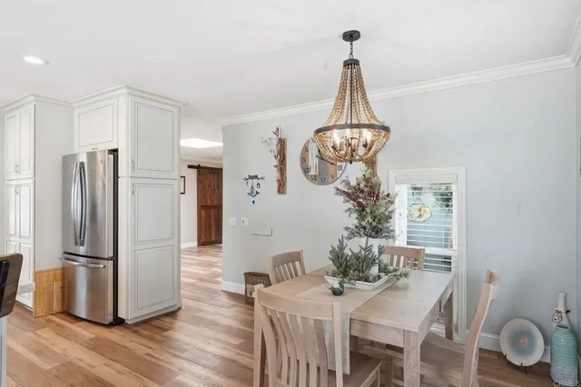 a view of a dining room with furniture wooden floor and a chandelier