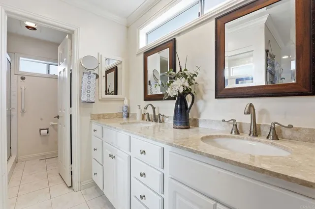 a bathroom with double sink and a mirror