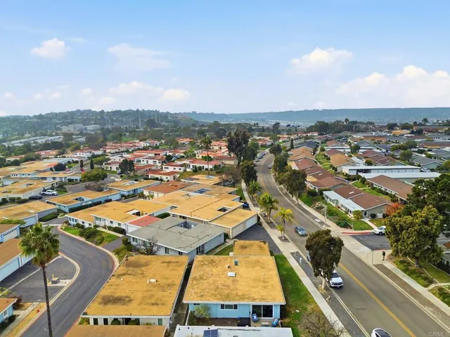an aerial view of a residential houses with city view