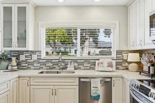 a kitchen with stainless steel appliances a sink and cabinets