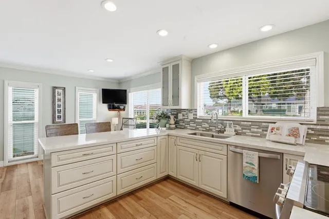 a kitchen with a sink stove and cabinets