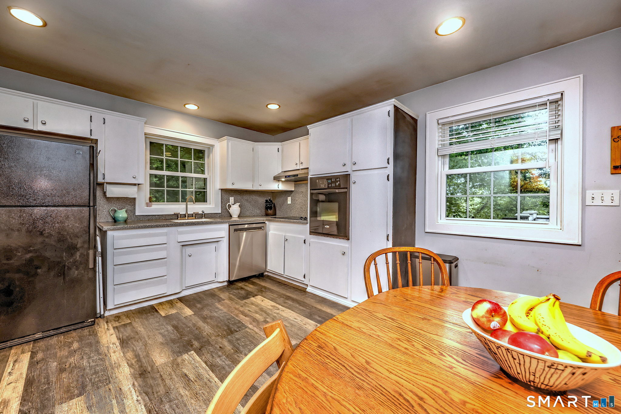 265 Shelter Rock Road Fairfield, CT 06825 - Photo 8 of 32 Updated and Sunny eat-in kitchen with white cabinetry and corian countertops. Plenty of counterspace!