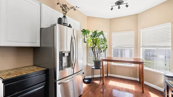 a kitchen with granite countertop a refrigerator and a sink
