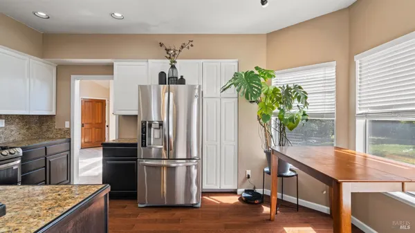 a kitchen with kitchen island a counter top space and stainless steel appliances