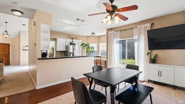 a view of a dining room with furniture and a livingroom