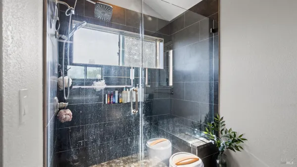 a view of a hallway with closet and a bathroom
