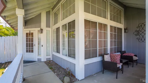 a view of a balcony with chair and tables