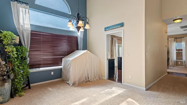 a view of a bedroom and chandelier fan
