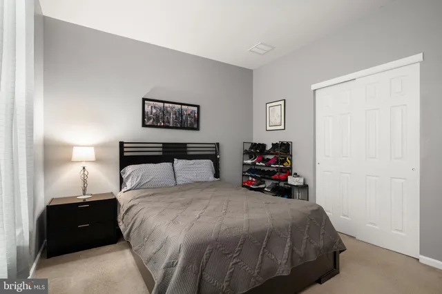 a bedroom with a bed and a large mirror