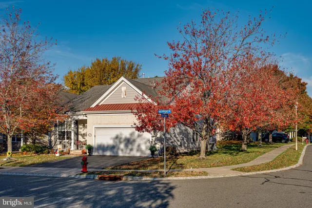 a view of a house with a yard and tree s