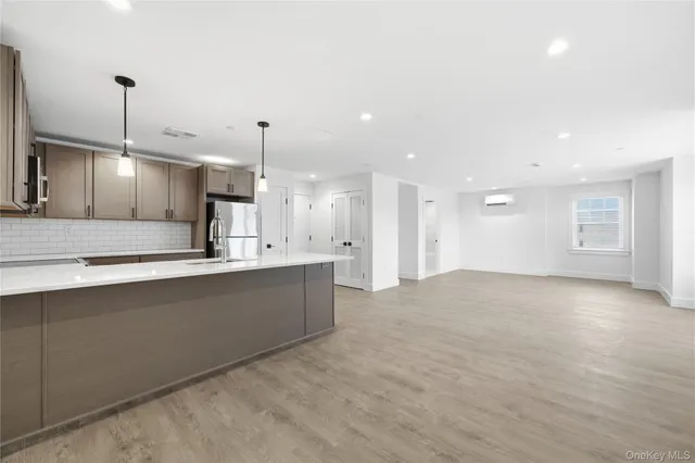 a large kitchen with stainless steel appliances kitchen island a large island in the center