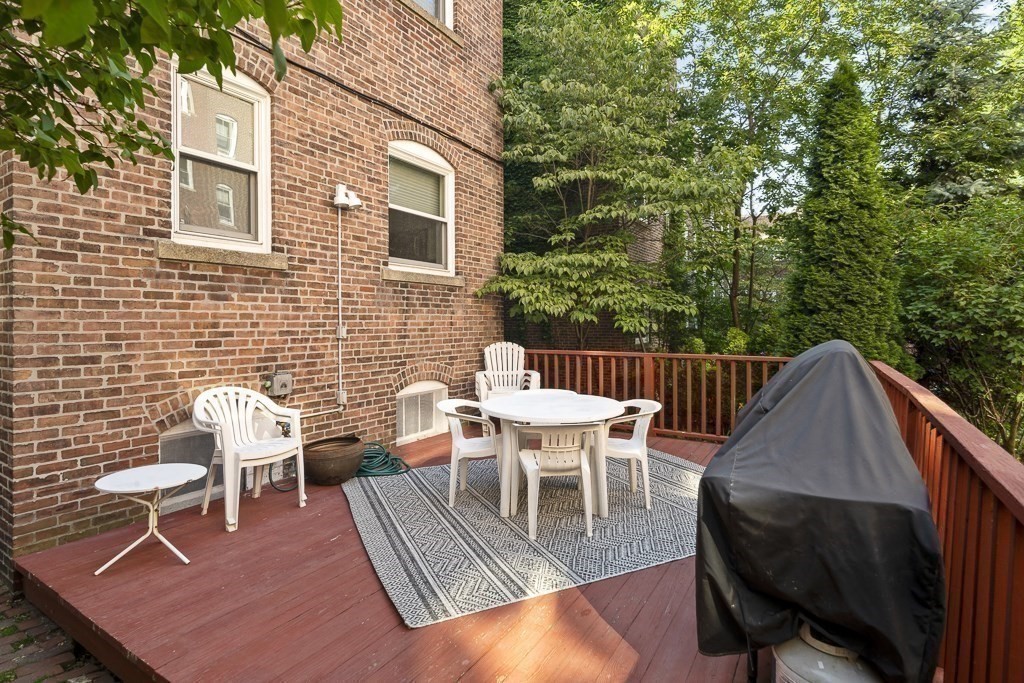 231 Rawson Road, Unit 6 Brookline, MA 02445 - Photo 11 of 11 a view of a patio with a table and chairs