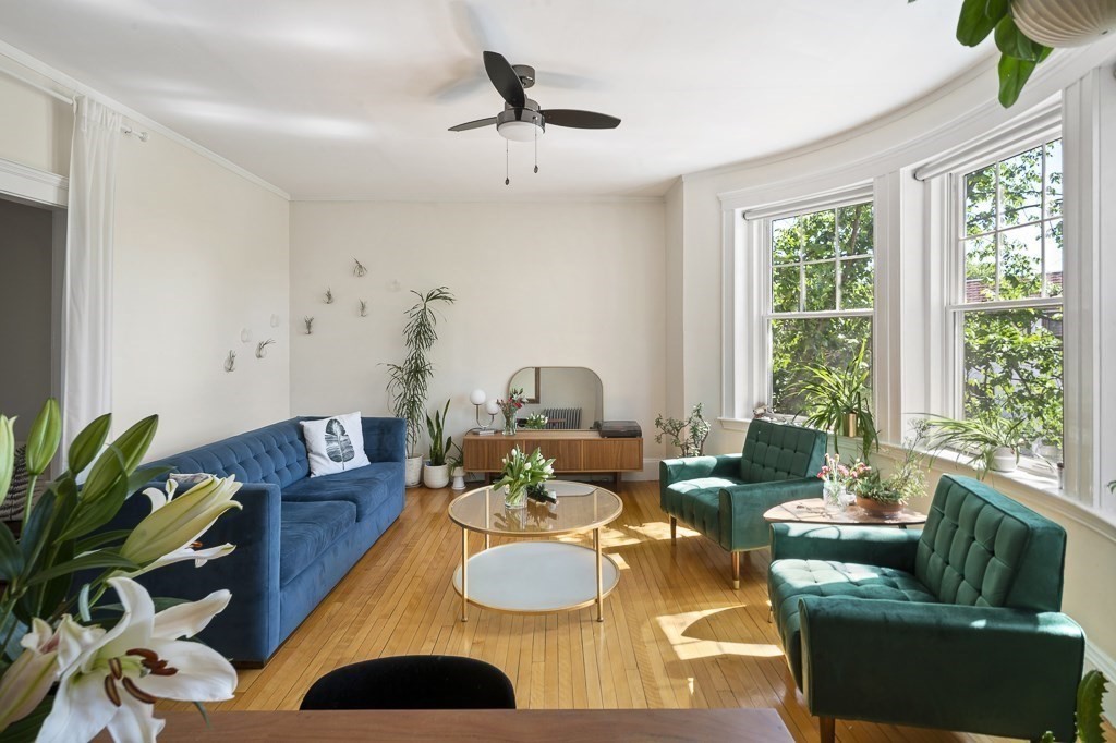 231 Rawson Road, Unit 6 Brookline, MA 02445 - Photo 2 of 11 a living room with furniture and a large window