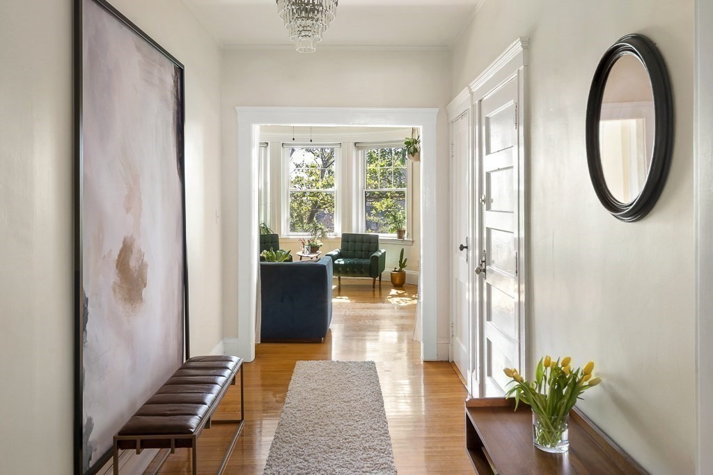 231 Rawson Road, Unit 6 Brookline, MA 02445 - Photo 6 of 11 a hallway with a potted plant on a table and potted plants