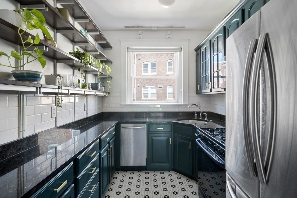 231 Rawson Road, Unit 6 Brookline, MA 02445 - Photo 7 of 11 a kitchen with stainless steel appliances a sink stove and refrigerator