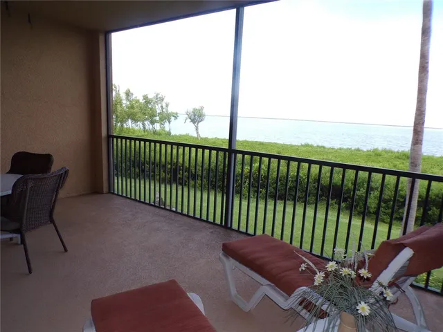 a view of a dining room and livingroom with furniture wooden floor a chandelier