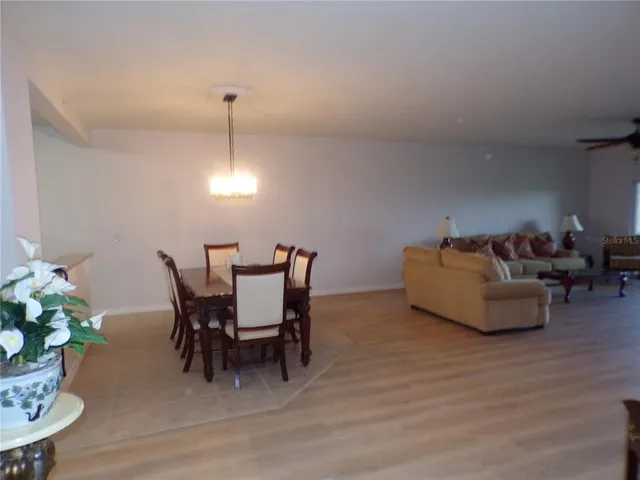 a kitchen with kitchen island granite countertop a stove refrigerator and microwave