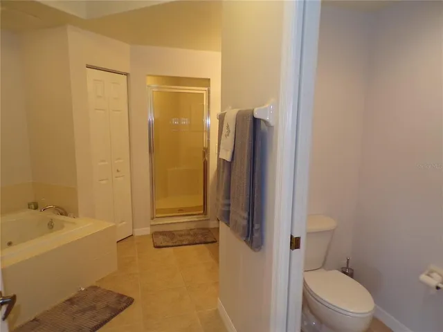 a bedroom with a bed and a lamp