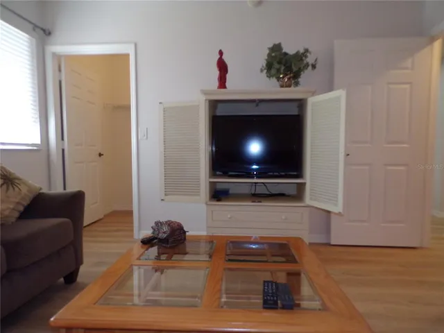 a bedroom with a bed and a lamp