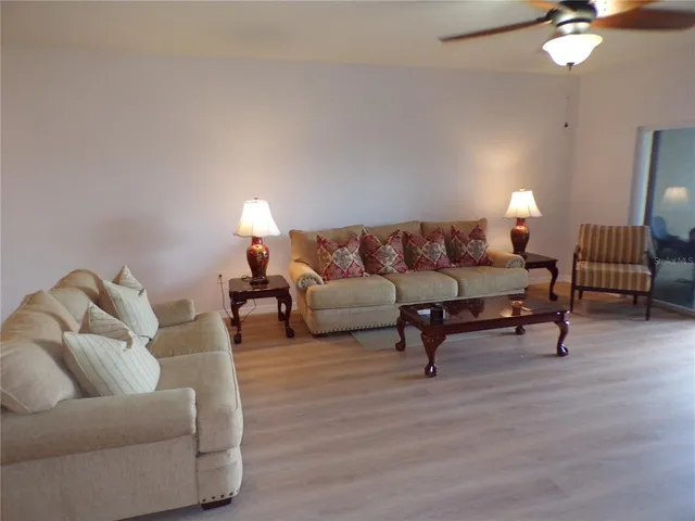 a living room with furniture and a lamp