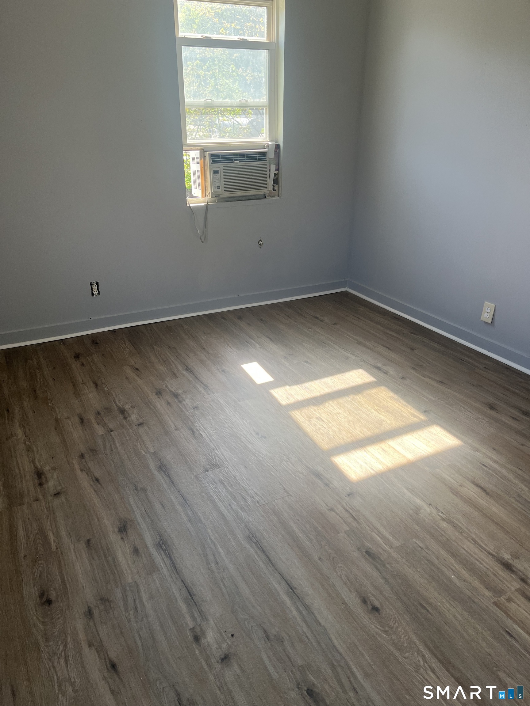 288 Cook Avenue Meriden, CT 06451 - Photo 10 of 11 an empty room with wooden floor and windows