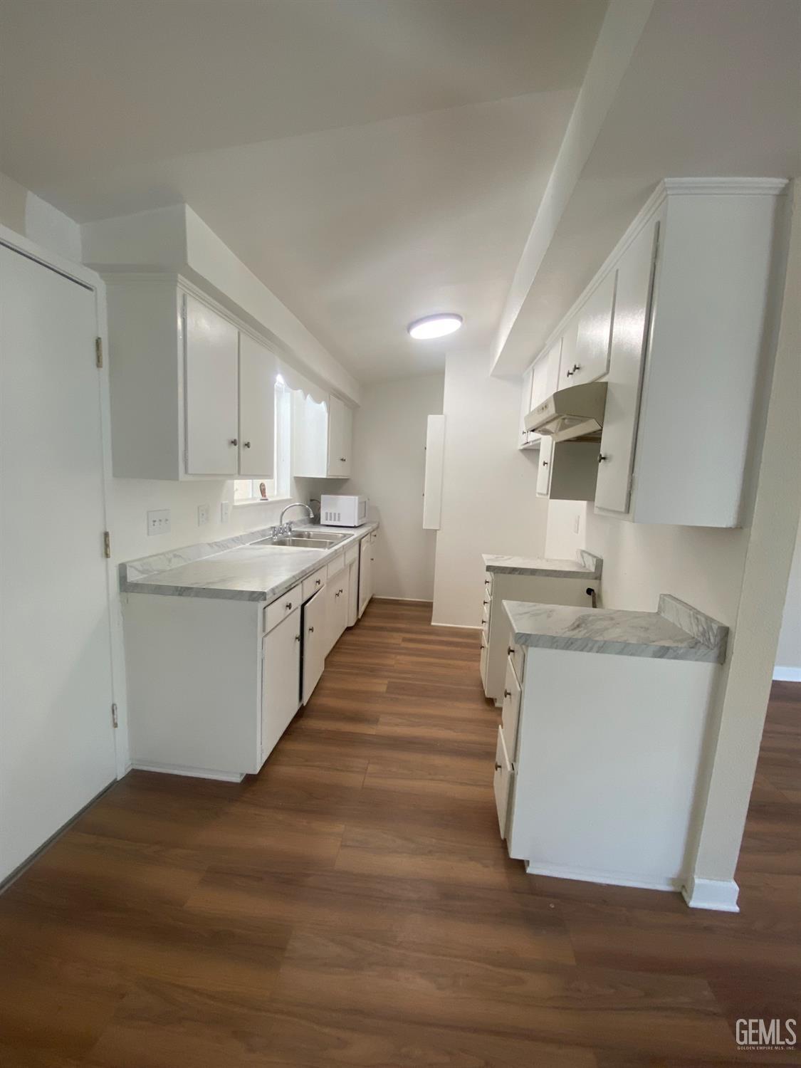Undisclosed Address Santa Ana, CA 92707 - Photo 11 of 40 a kitchen with a sink stove and cabinets