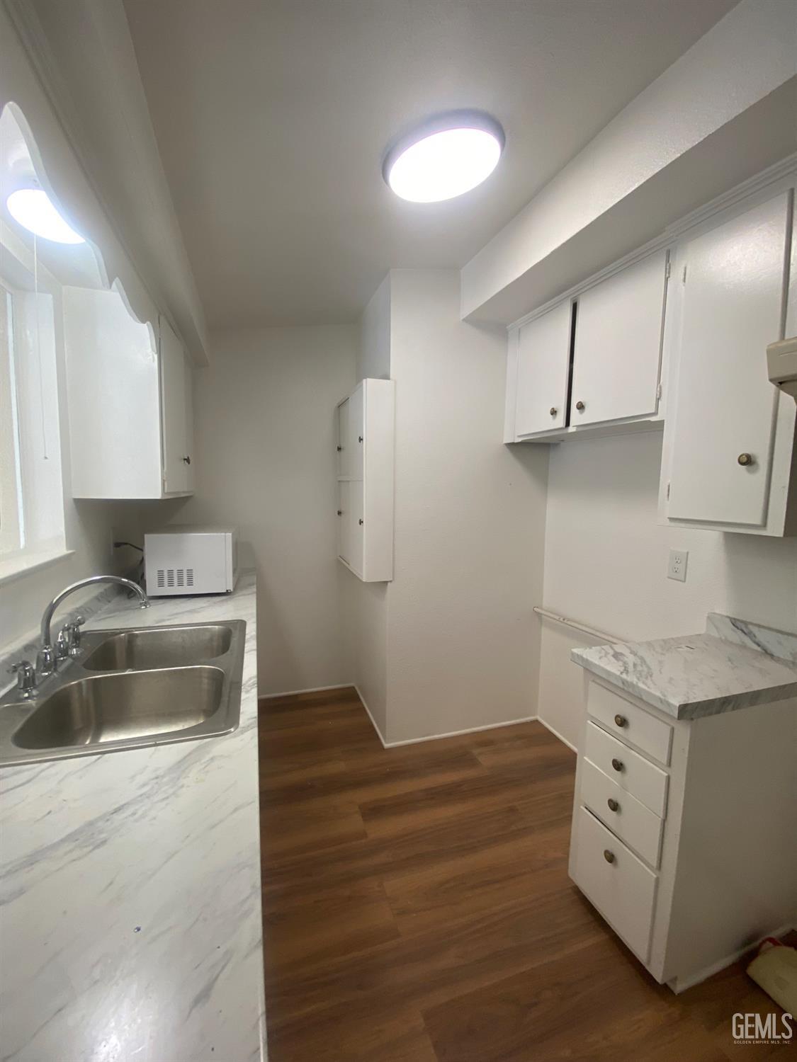 Undisclosed Address Santa Ana, CA 92707 - Photo 15 of 40 a kitchen with cabinets appliances and a counter space