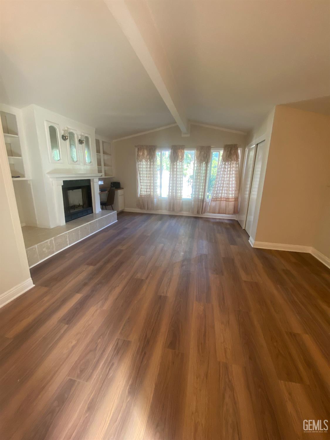 Undisclosed Address Santa Ana, CA 92707 - Photo 17 of 40 wooden floor fireplace and windows in an empty room