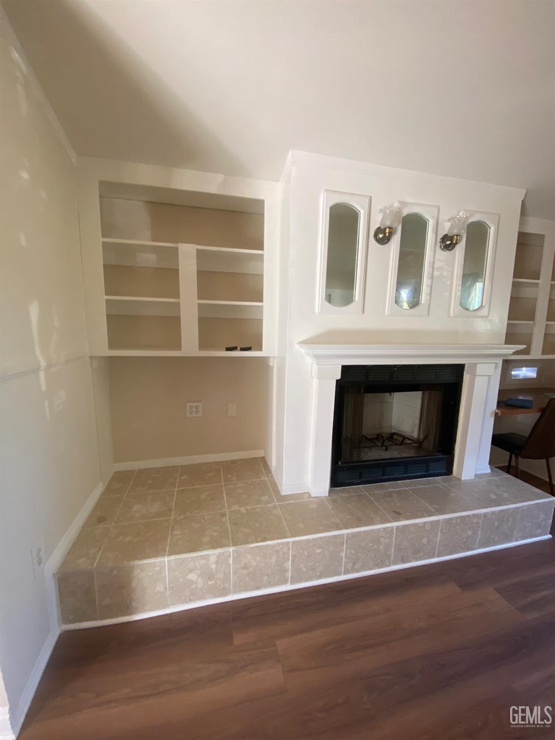 Undisclosed Address Santa Ana, CA 92707 - Photo 21 of 40 a view of a livingroom with an empty space & a fireplace