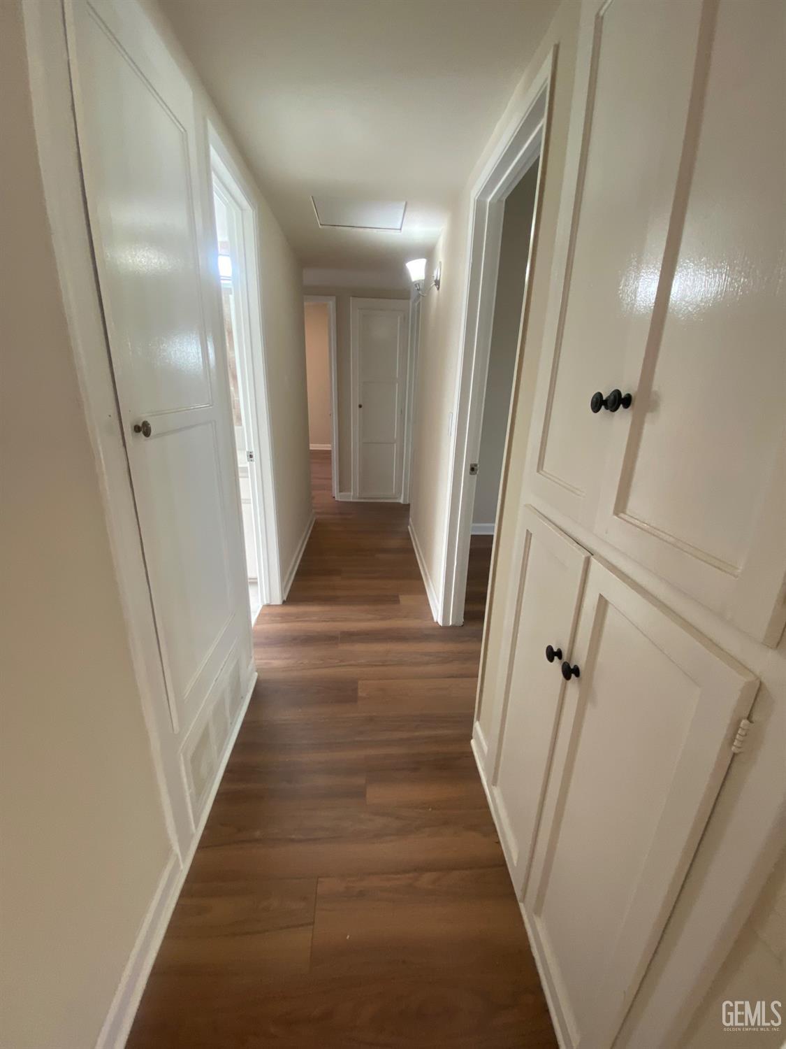 Undisclosed Address Santa Ana, CA 92707 - Photo 23 of 40 a view of a hallway with wooden floor and staircase