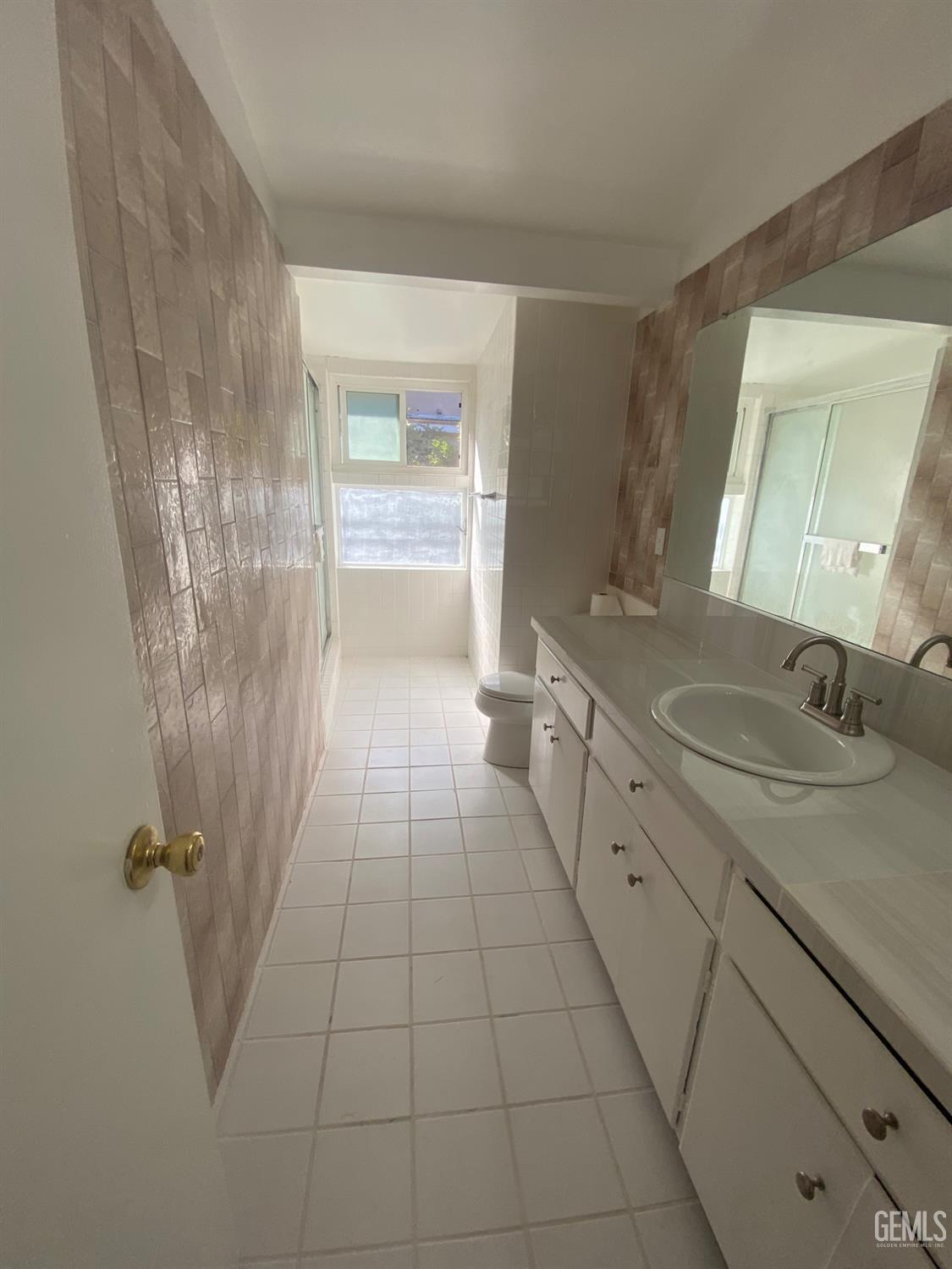 Undisclosed Address Santa Ana, CA 92707 - Photo 25 of 40 a bathroom with a granite countertop sink a mirror and a shower