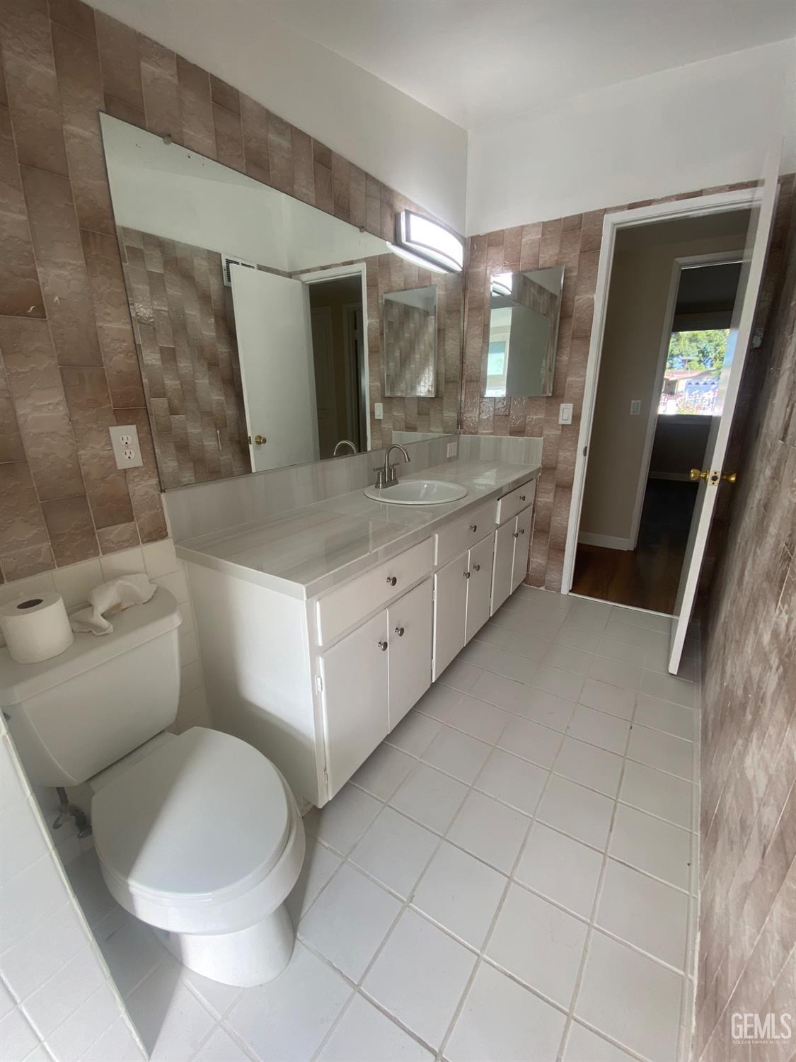 Undisclosed Address Santa Ana, CA 92707 - Photo 30 of 40 a bathroom with a granite countertop sink and a mirror