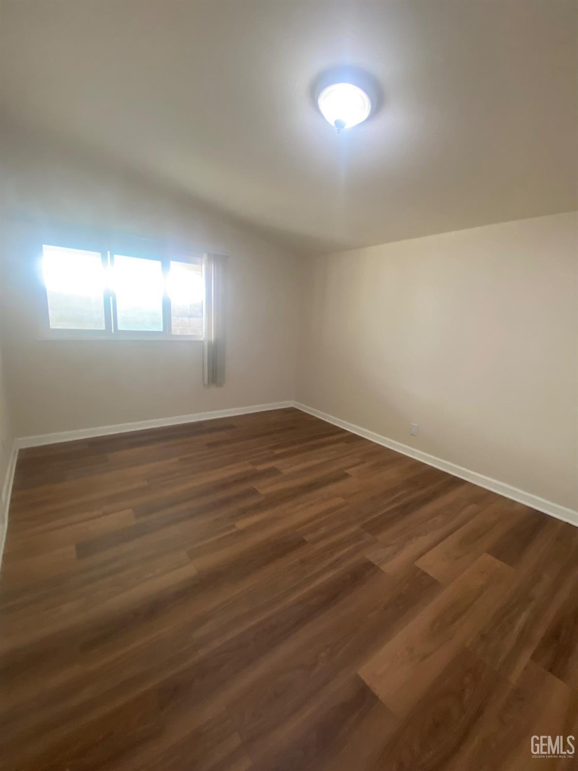 Undisclosed Address Santa Ana, CA 92707 - Photo 33 of 40 an empty room with wooden floor and windows