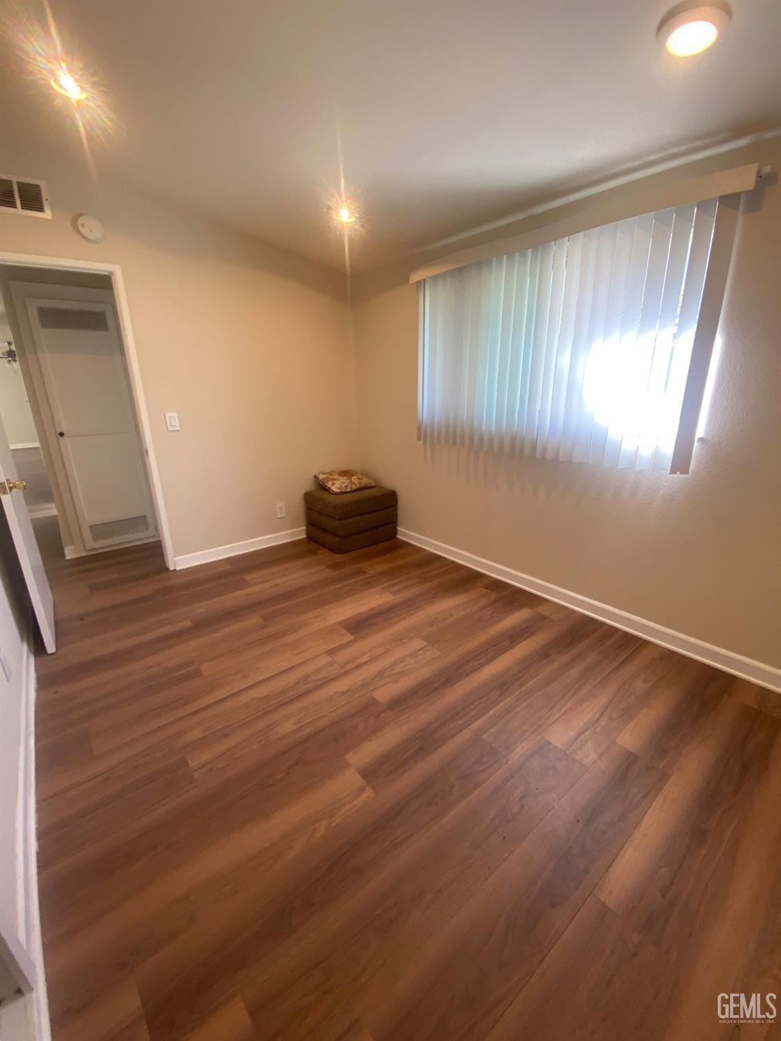 Undisclosed Address Santa Ana, CA 92707 - Photo 34 of 40 a view of an empty room with wooden floor and a window