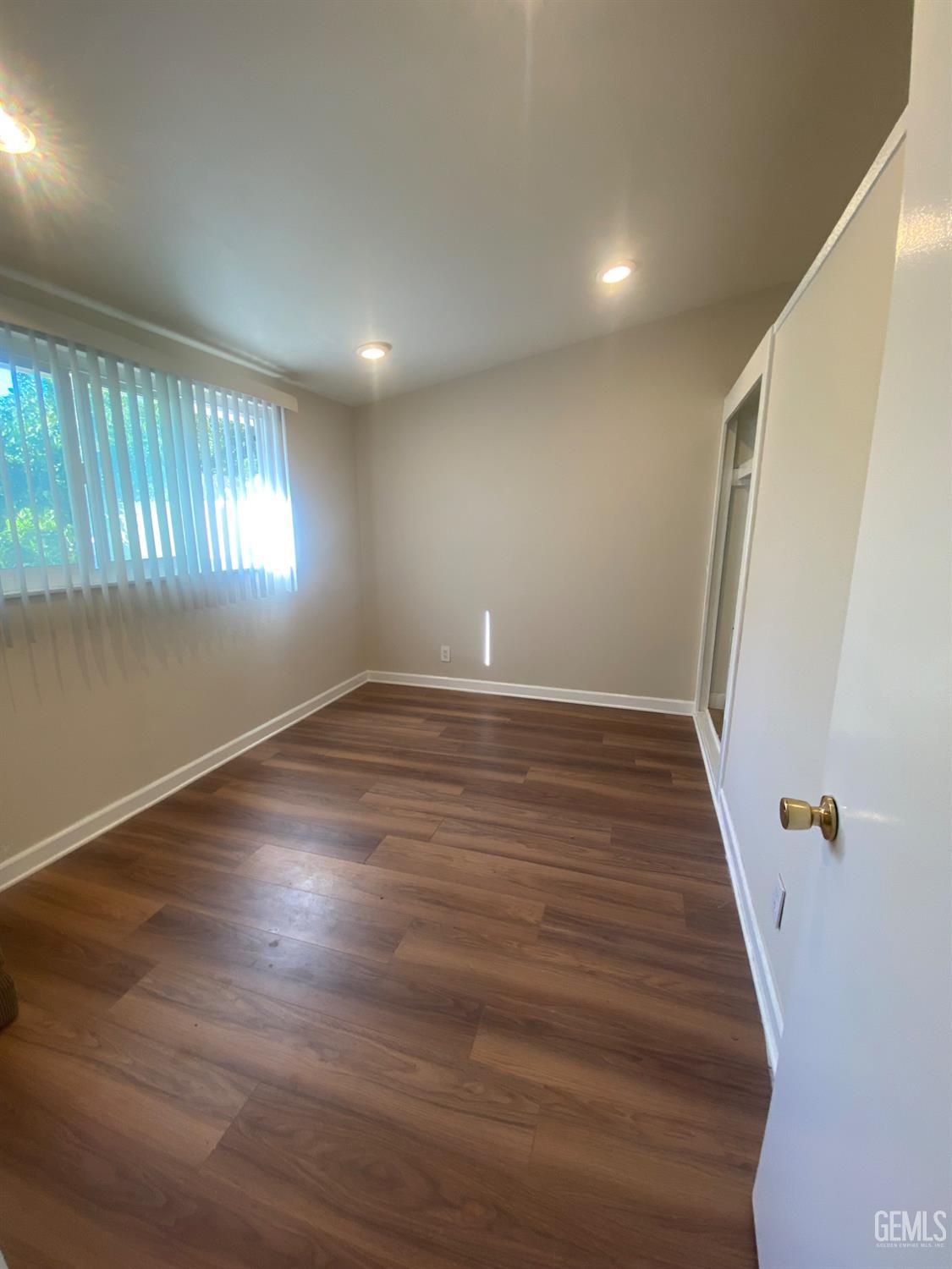 Undisclosed Address Santa Ana, CA 92707 - Photo 35 of 40 an empty room with wooden floor and windows