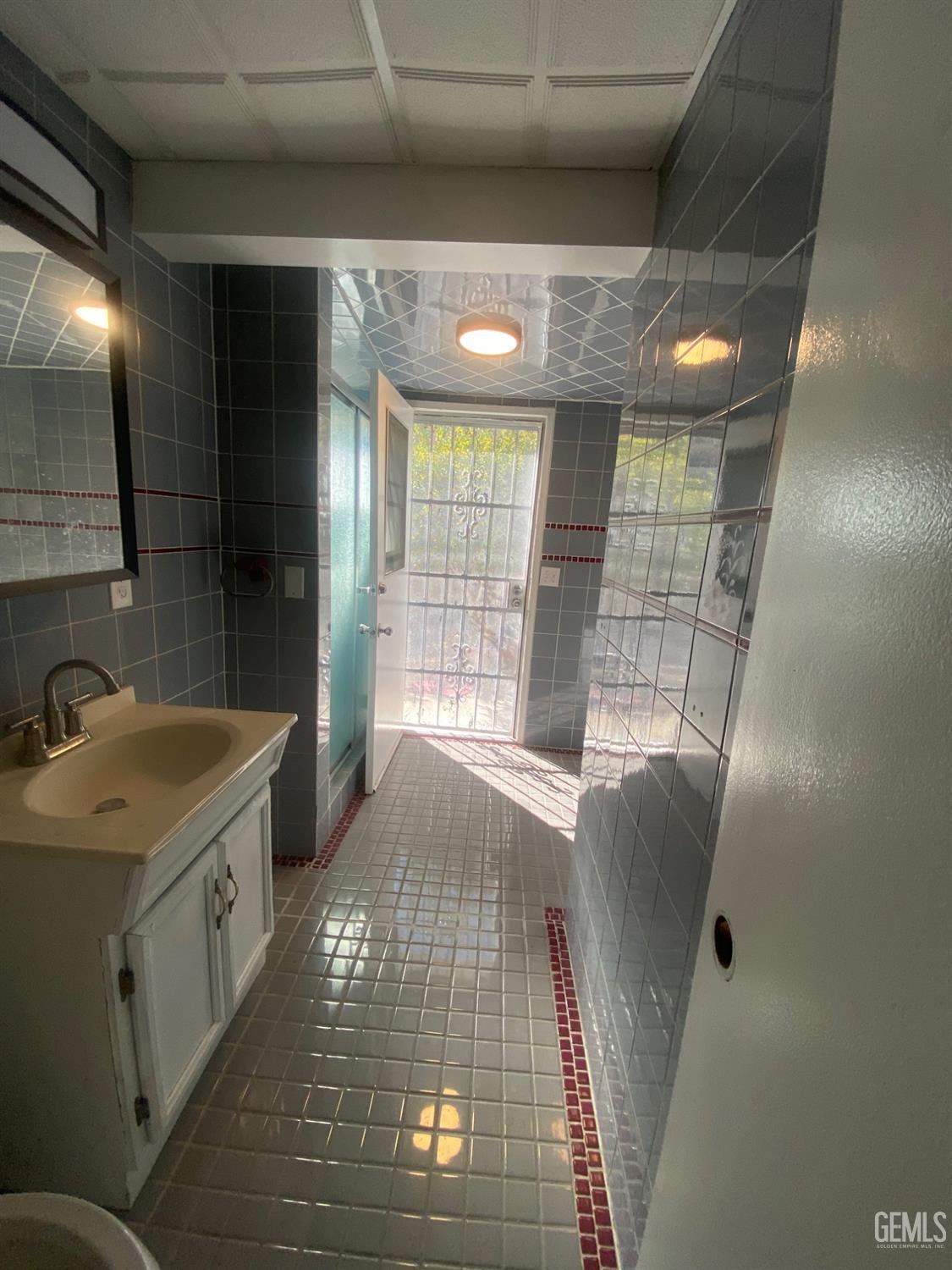 Undisclosed Address Santa Ana, CA 92707 - Photo 37 of 40 a bathroom with a sink shower and a mirror