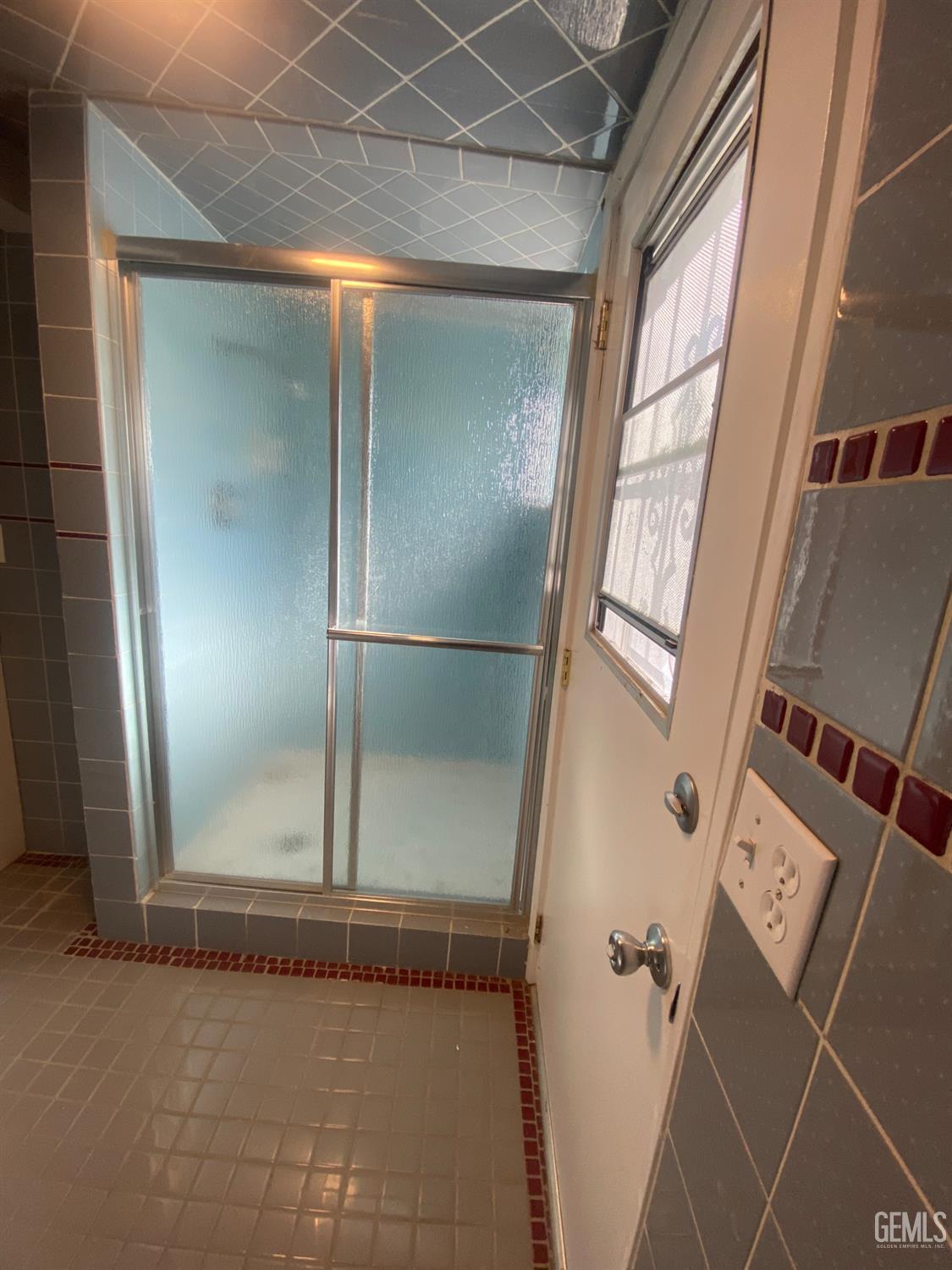 Undisclosed Address Santa Ana, CA 92707 - Photo 39 of 40 a bathroom with a glass shower door