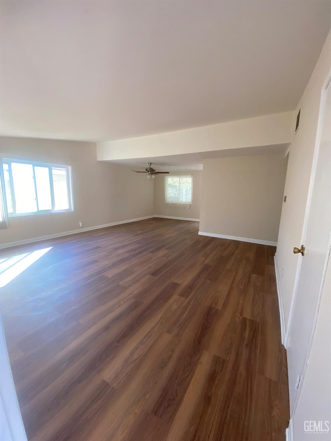 Undisclosed Address Santa Ana, CA 92707 - Photo 8 of 40 an empty room with wooden floor and windows
