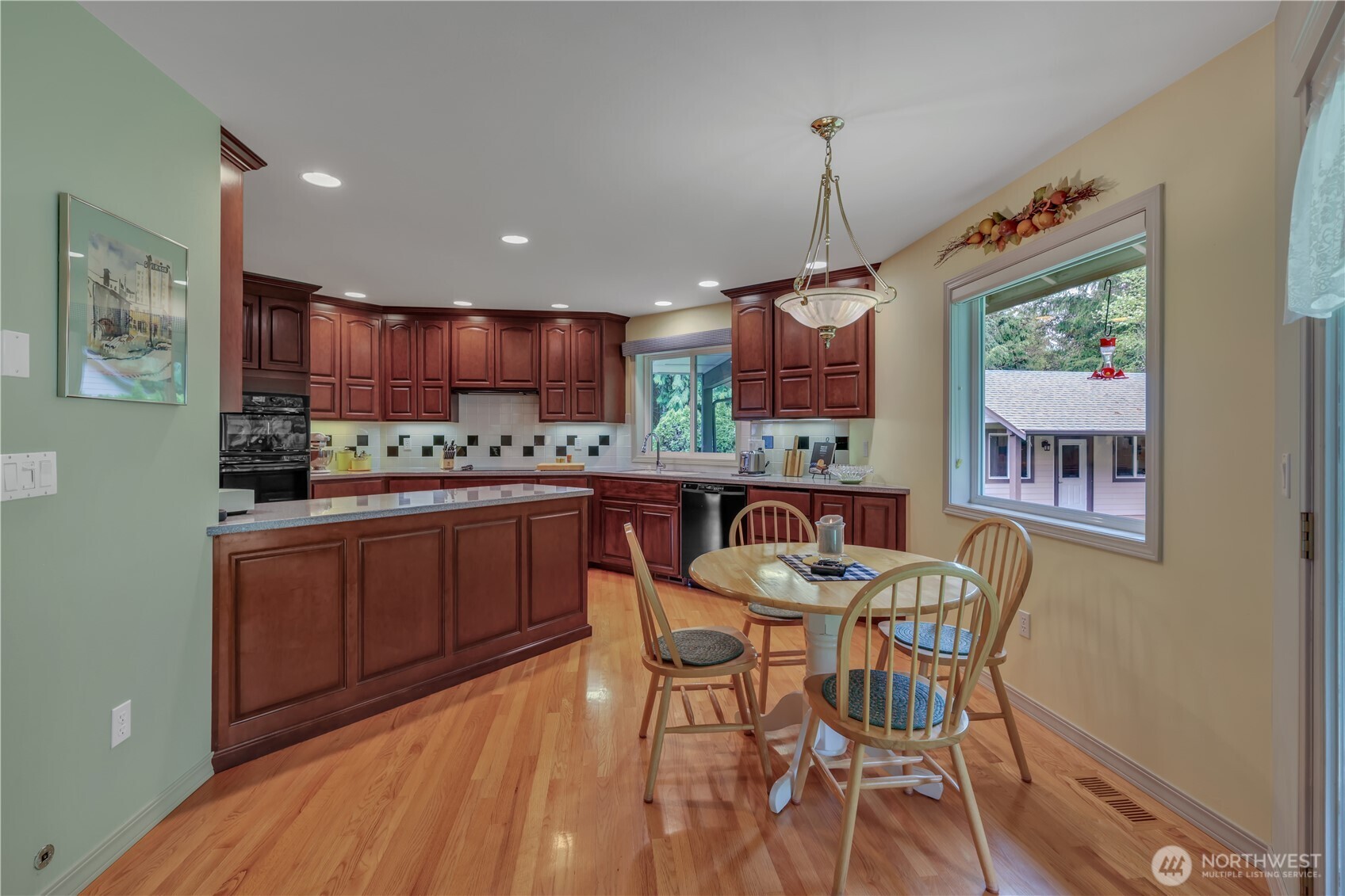 103 Southeast Alder Manor Road Shelton, WA 98584 - Photo 11 of 39 a kitchen with stainless steel appliances granite countertop a refrigerator a stove top oven a sink with island and chairs