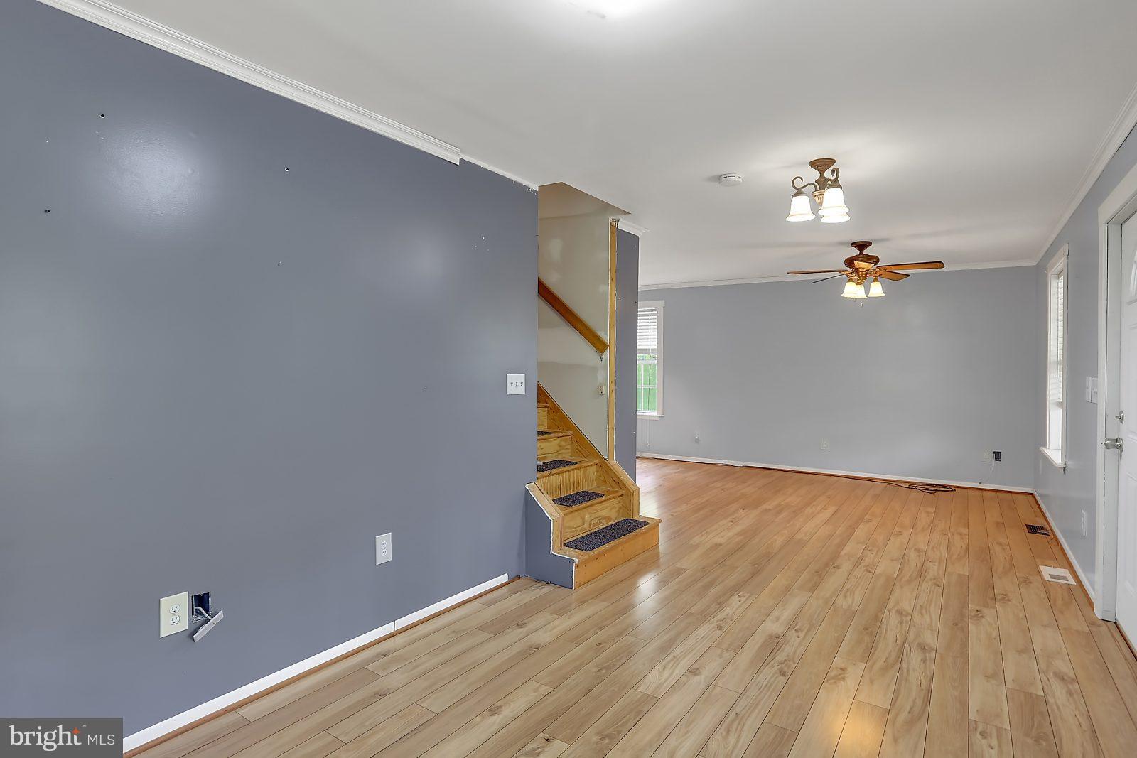 2443 Ridge Road Baltimore, MD 21244 - Photo 3 of 28 wooden floor in an empty room with a window